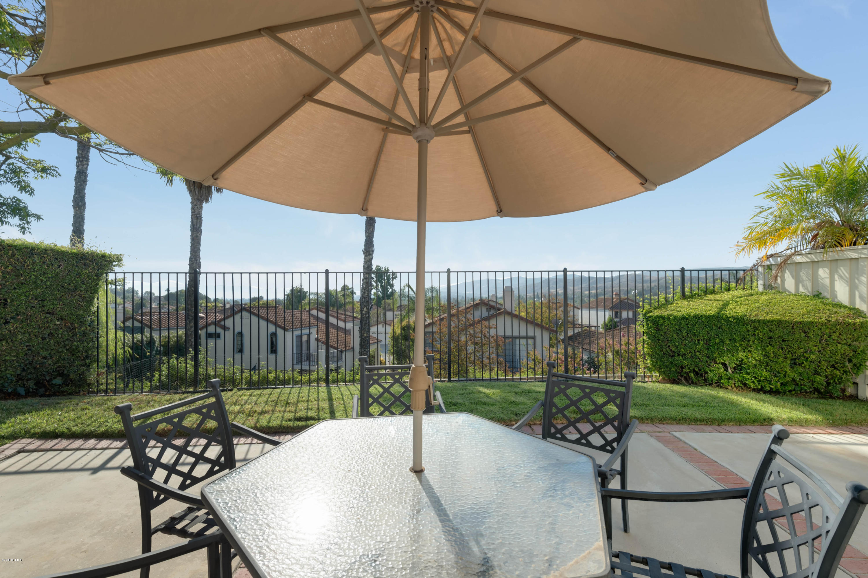 844 Congressional Road Simi Valley, CA 93065 - Photo 7 of 38 a view of a patio with a table and chairs under an umbrella