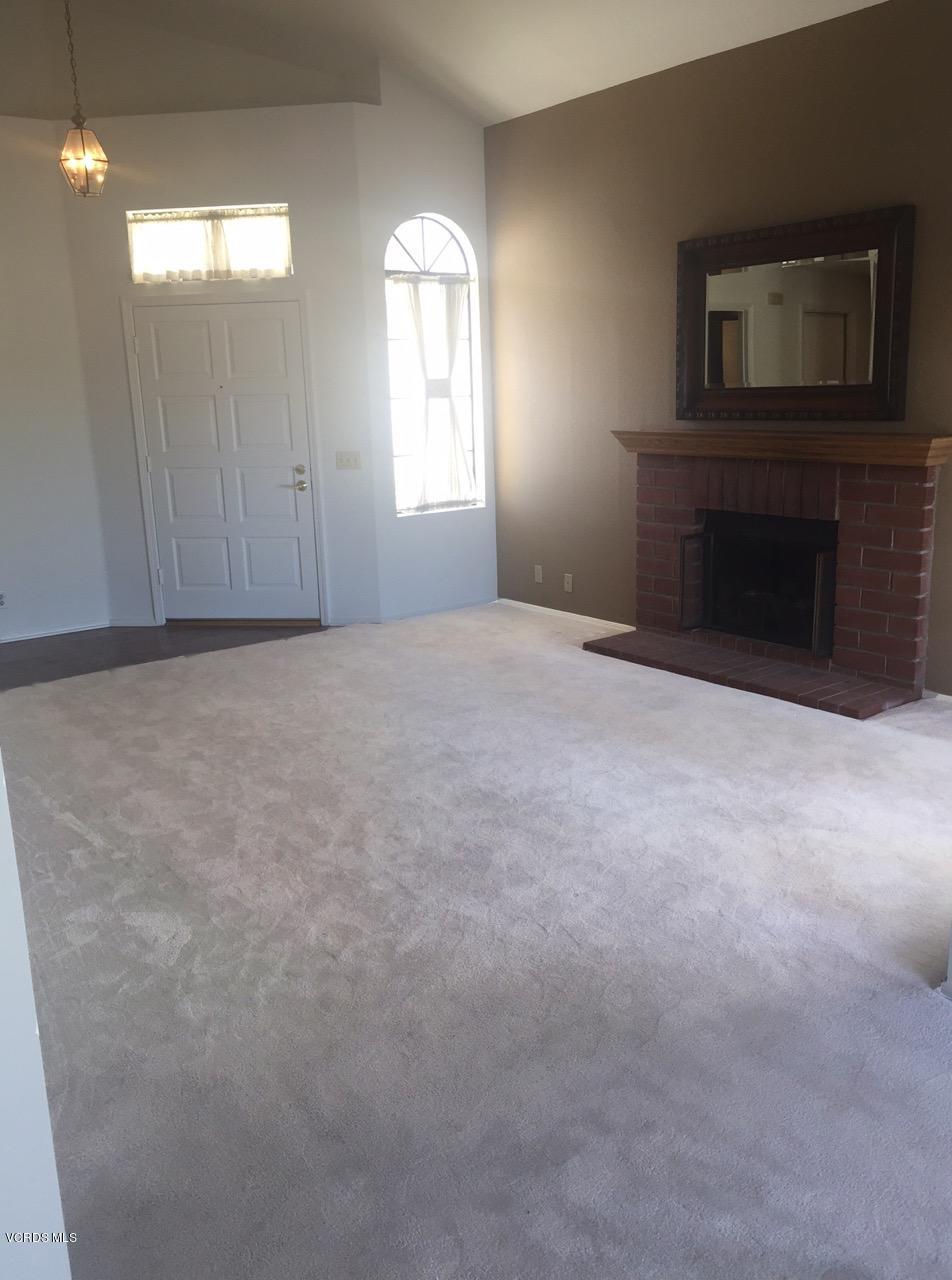844 Congressional Road Simi Valley, CA 93065 - Photo 8 of 38 a view of an empty room with a fireplace and a window