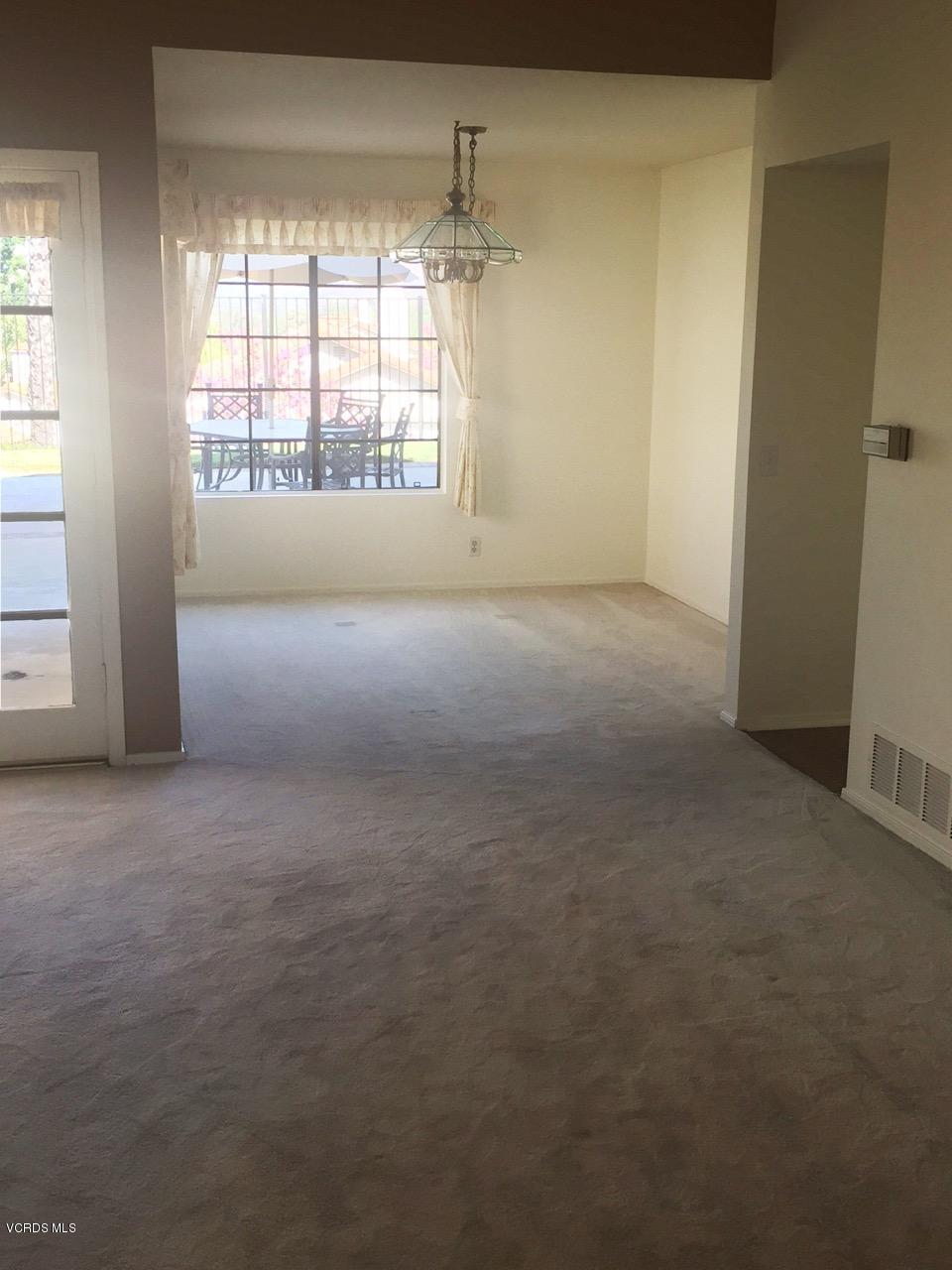 844 Congressional Road Simi Valley, CA 93065 - Photo 9 of 38 an empty room with a fireplace and windows