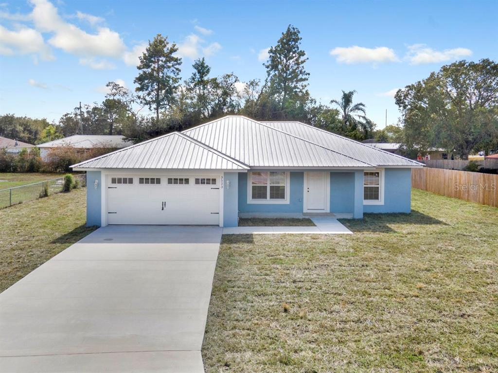 14081 Southwest 30th Ter Road Ocala, FL 34473 - Photo 1 of 1 a view of a house with a yard and garage