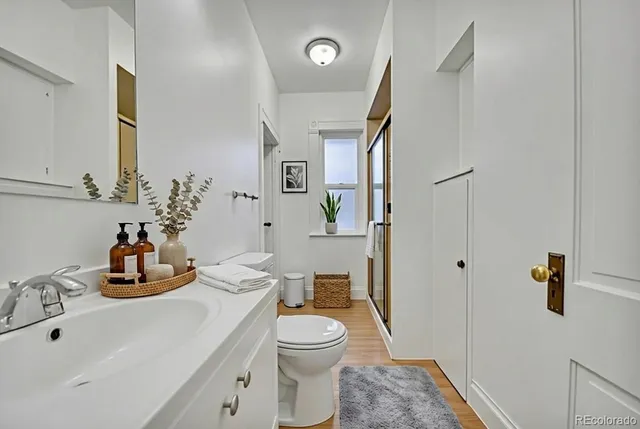 a bathroom with a toilet a sink and shower