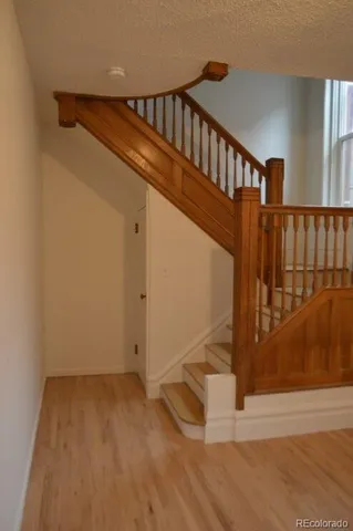 a view of staircase with white walls and a window