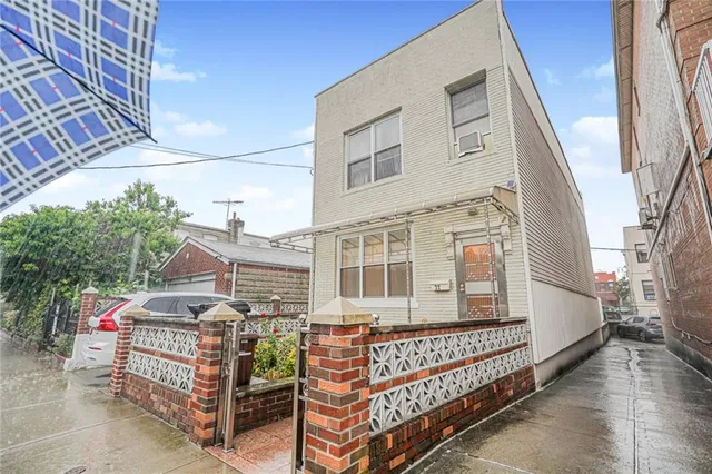 a front view of a house with balcony and stairs