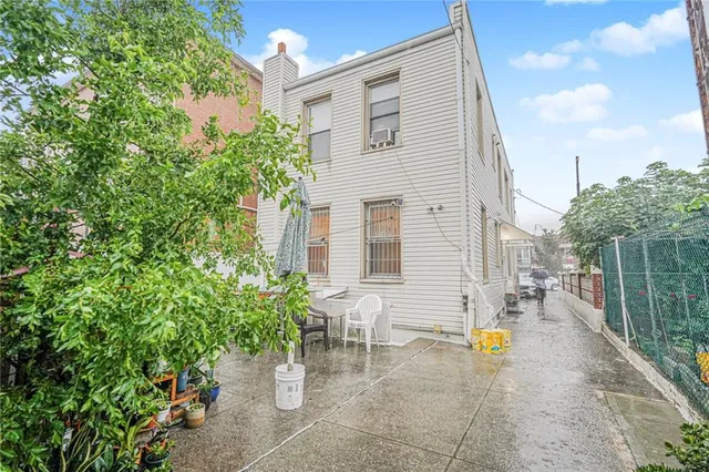 a view of a patio with table and chairs and potted plants