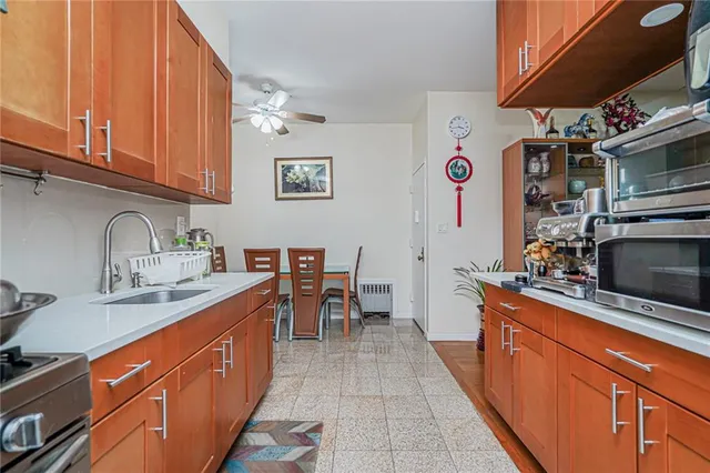 a kitchen with stainless steel appliances granite countertop a sink stove and microwave