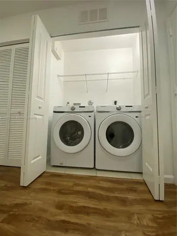an empty room with wooden floor and a window