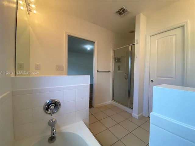 a view of a street with potted plants