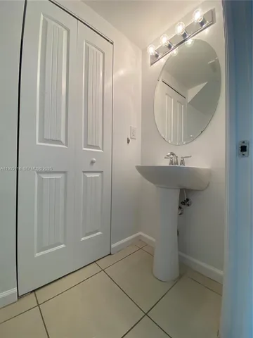 a kitchen with kitchen island granite countertop a sink a stove and a refrigerator