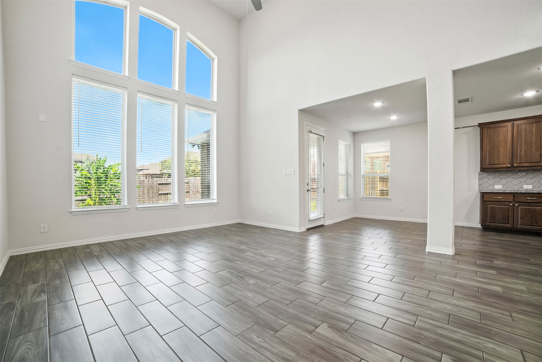 3054 Columbus Loop Round Rock, TX 78665 - Photo 6 of 40 Unfurnished living room featuring wood finish floors, a high ceiling, and recessed lighting