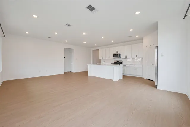a view of a kitchen with a sink and microwave