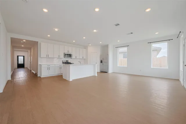 a view of a kitchen with a sink and a refrigerator