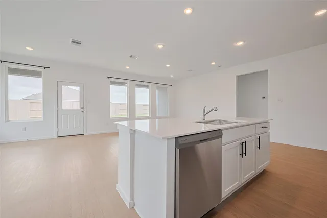 a view of cabinets a sink and wooden floor