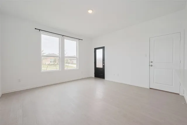 an empty room with windows and closet