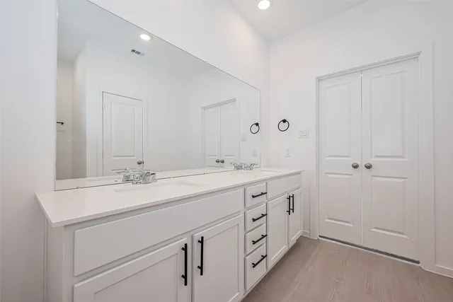 a bathroom with a double vanity sink and mirror