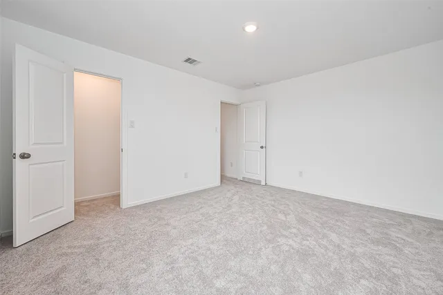 a view of a house with backyard and a tree