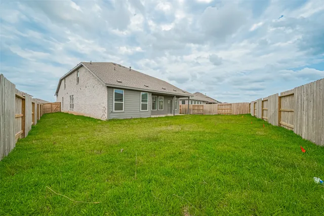 a view of a house with a backyard