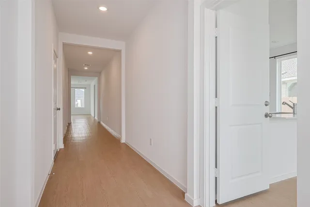 a view of a hallway with wooden floor