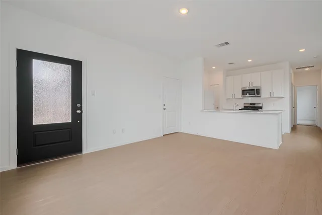 a view of a kitchen with a sink and cabinets