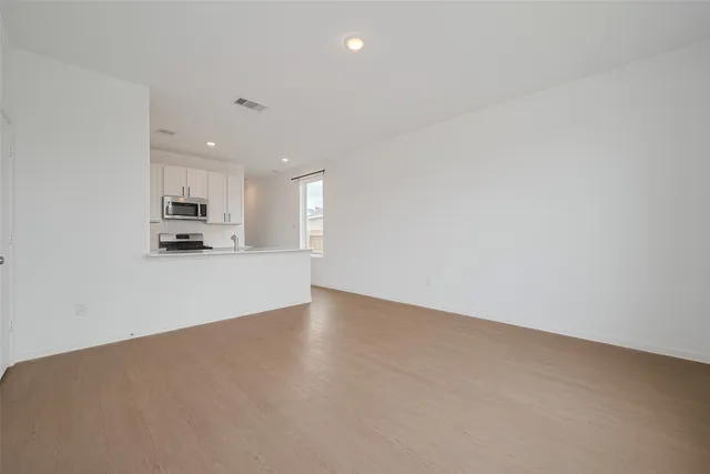 a view of a kitchen with an empty space and a window