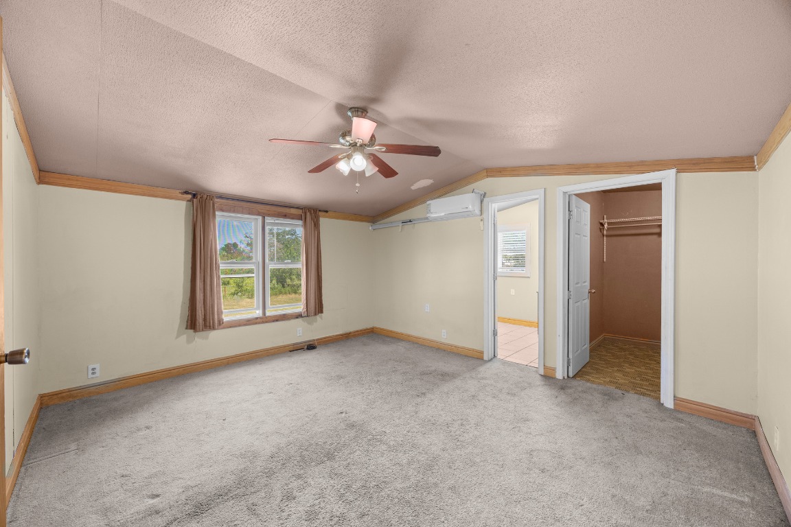 147 Community Center Road Rosanky, TX 78953 - Photo 13 of 33 an empty room with windows and fan