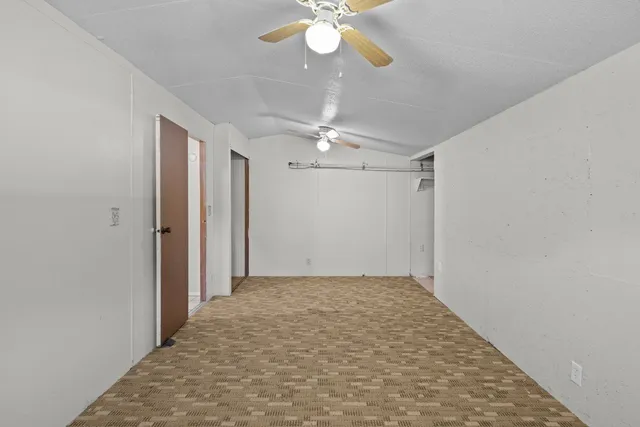 a view of backyard with swimming pool and sitting area