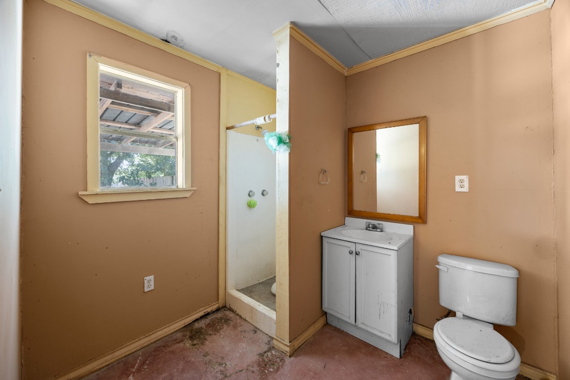 147 Community Center Road Rosanky, TX 78953 - Photo 28 of 33 a bathroom with a toilet a sink a vanity and mirror