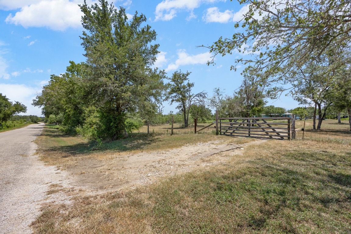 147 Community Center Road Rosanky, TX 78953 - Photo 3 of 33 a view of dirt yard with a trees