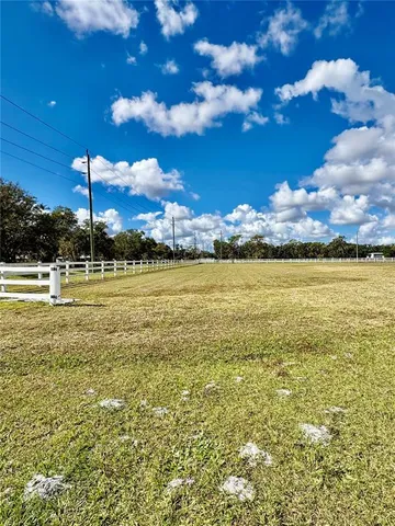 a view of a large pool with an ocean view