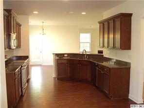 233 Lorraine Road Fort Mill, SC 29708 - Photo 5 of 16 a kitchen with stainless steel appliances granite countertop a sink stove and refrigerator