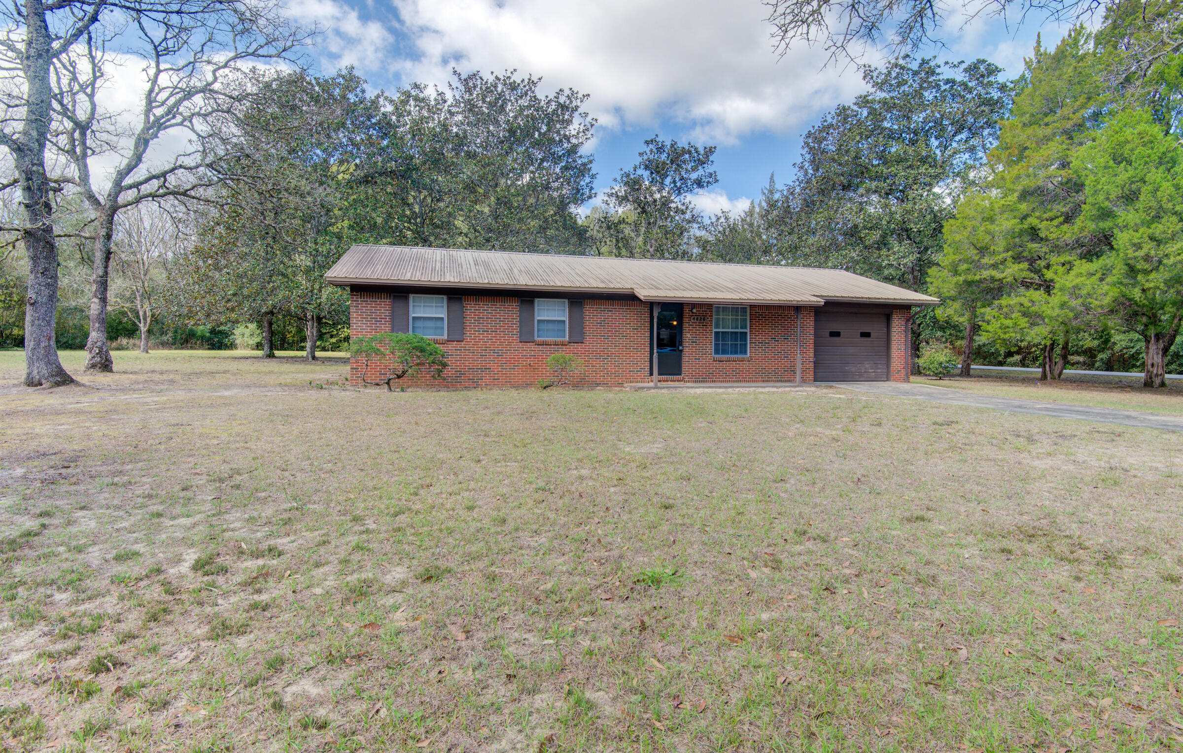 4826 Primrose Street Crestview, FL 32539 - Photo 12 of 25 a house with trees in the background