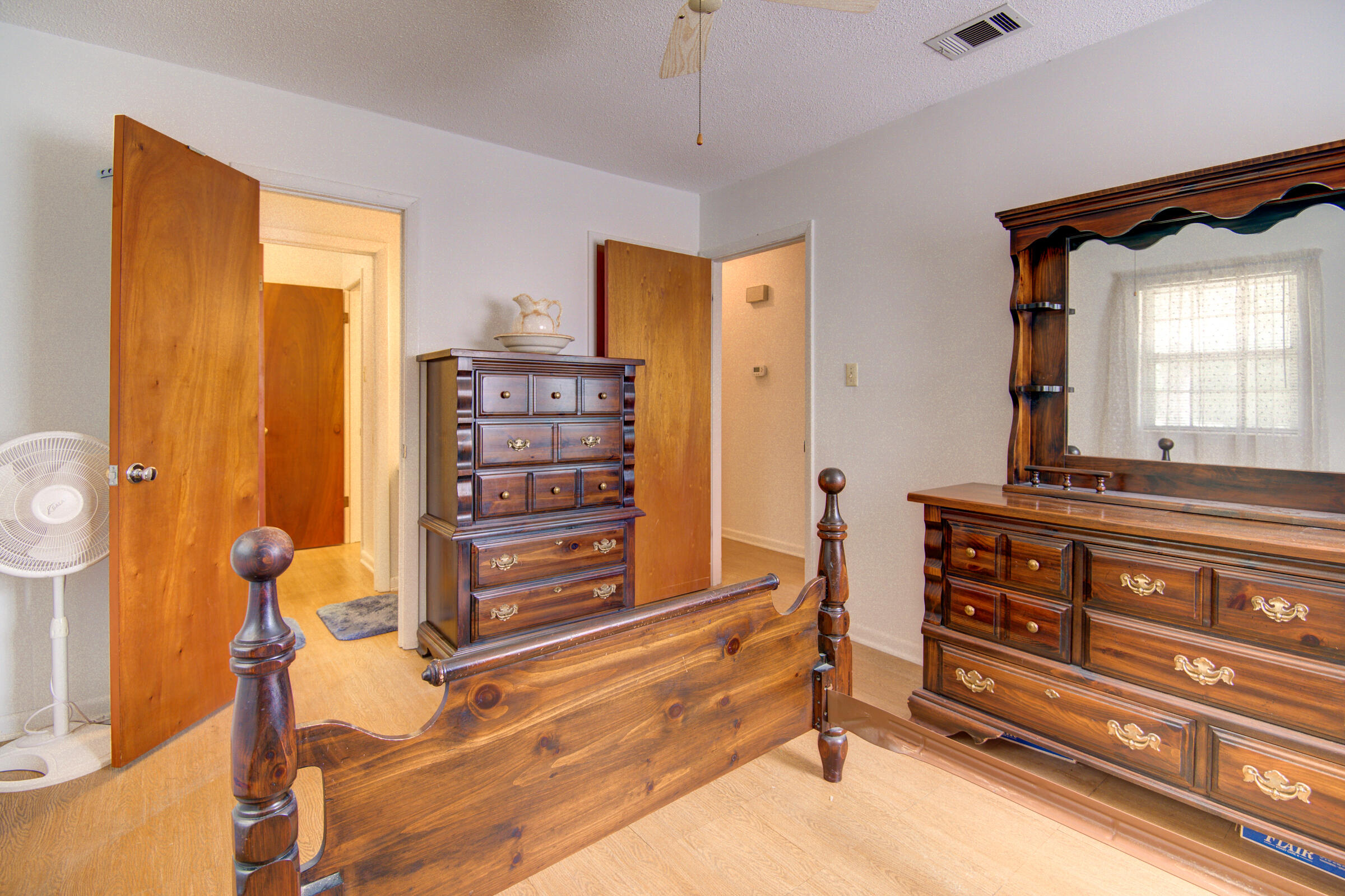 4826 Primrose Street Crestview, FL 32539 - Photo 15 of 25 a bedroom with a bed and a dresser