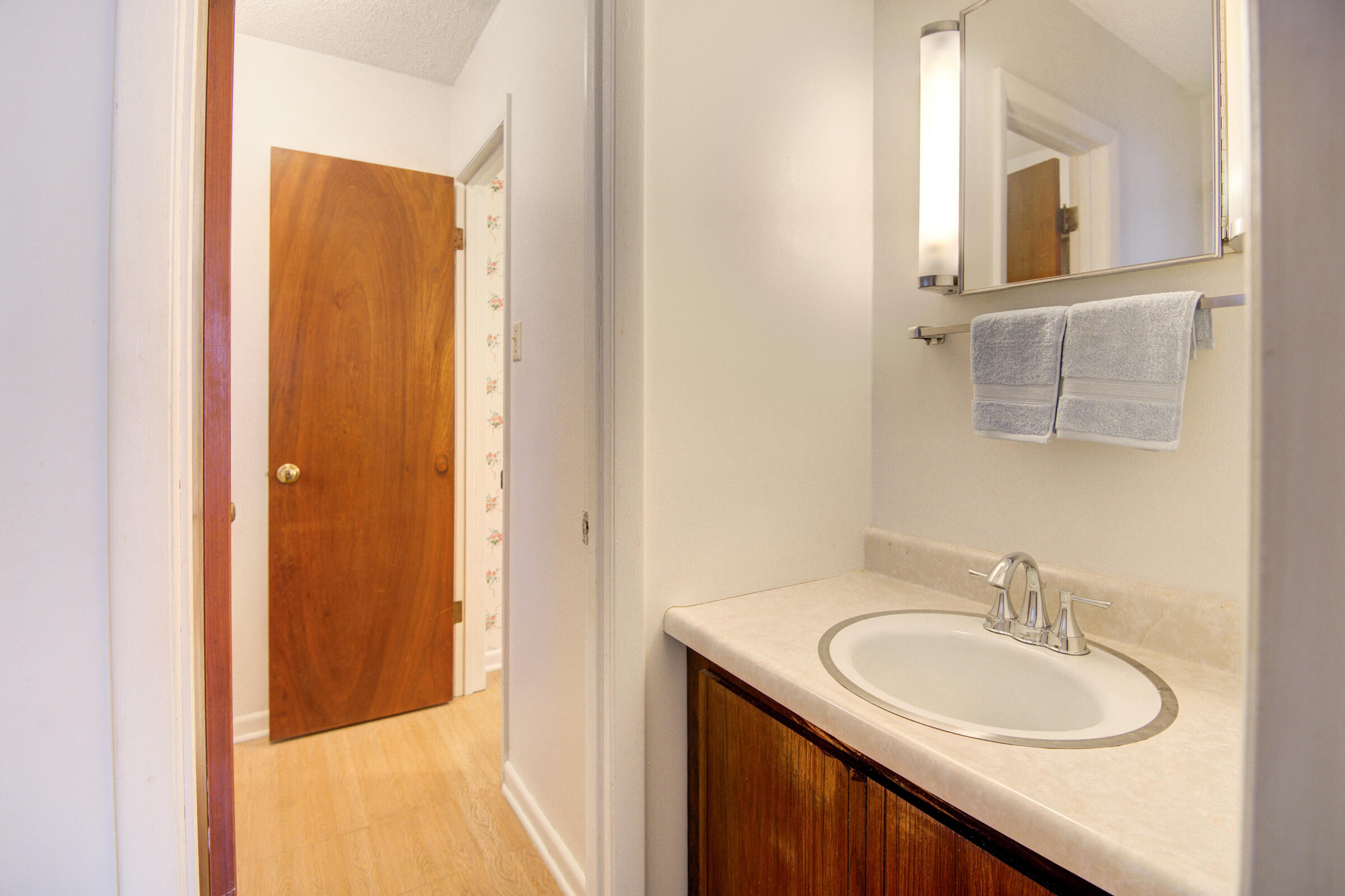 4826 Primrose Street Crestview, FL 32539 - Photo 16 of 25 a bathroom with a granite countertop sink and a mirror