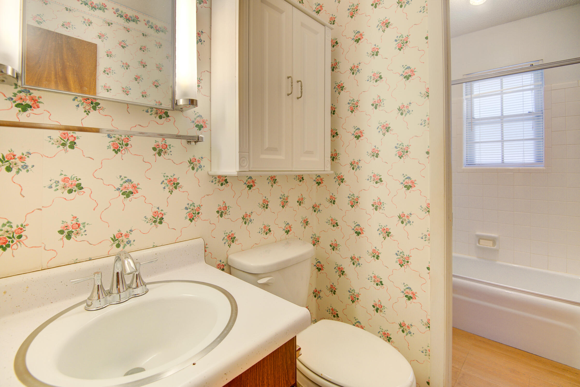 4826 Primrose Street Crestview, FL 32539 - Photo 17 of 25 a bathroom with a sink a toilet and shower curtain
