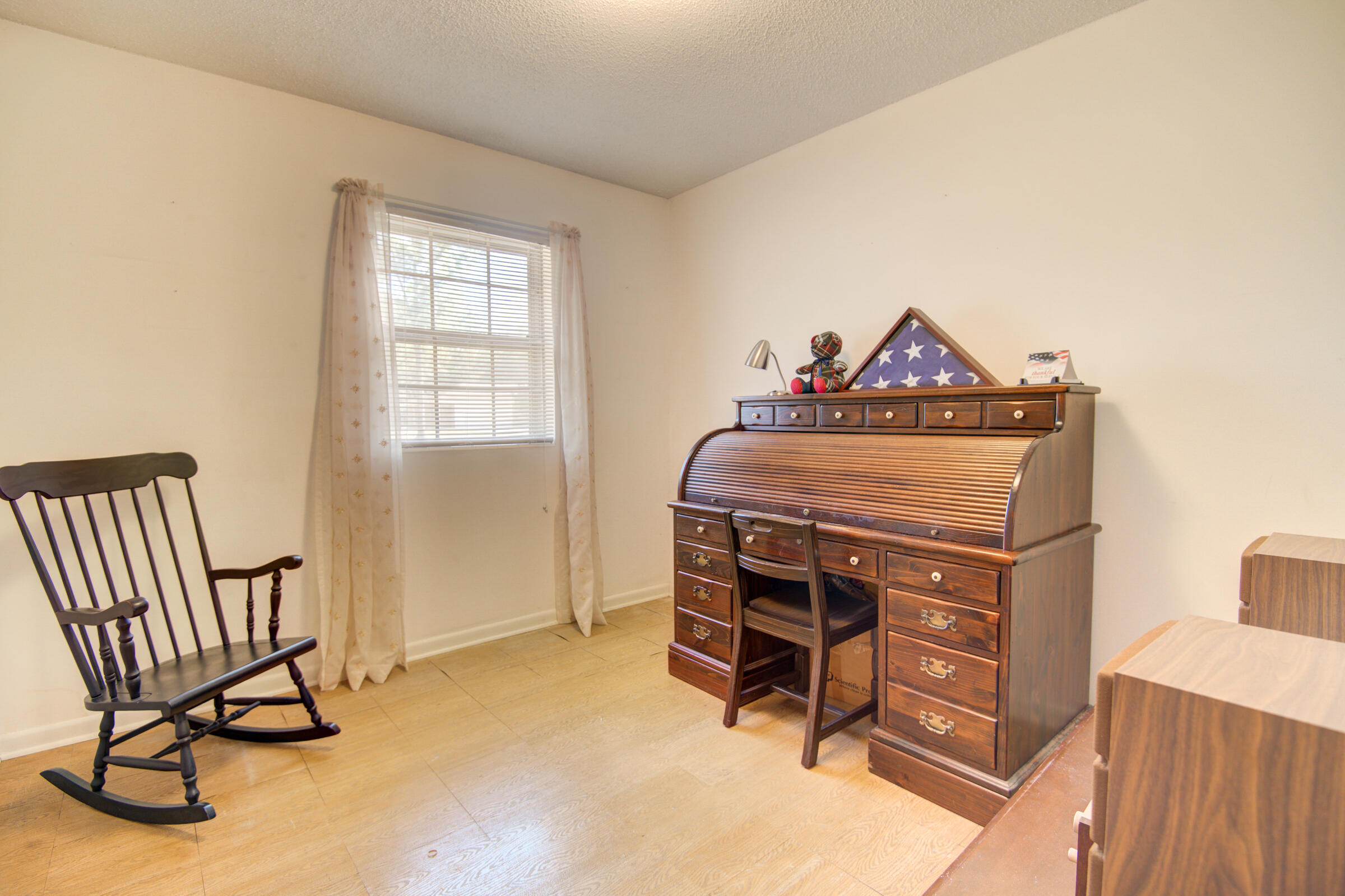 4826 Primrose Street Crestview, FL 32539 - Photo 18 of 25 a bed room with a bed and a chair