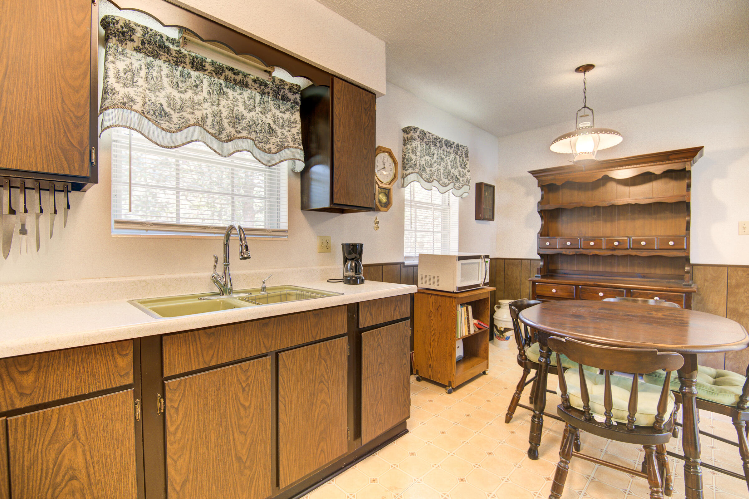 4826 Primrose Street Crestview, FL 32539 - Photo 23 of 25 a kitchen with a table chairs sink and cabinets