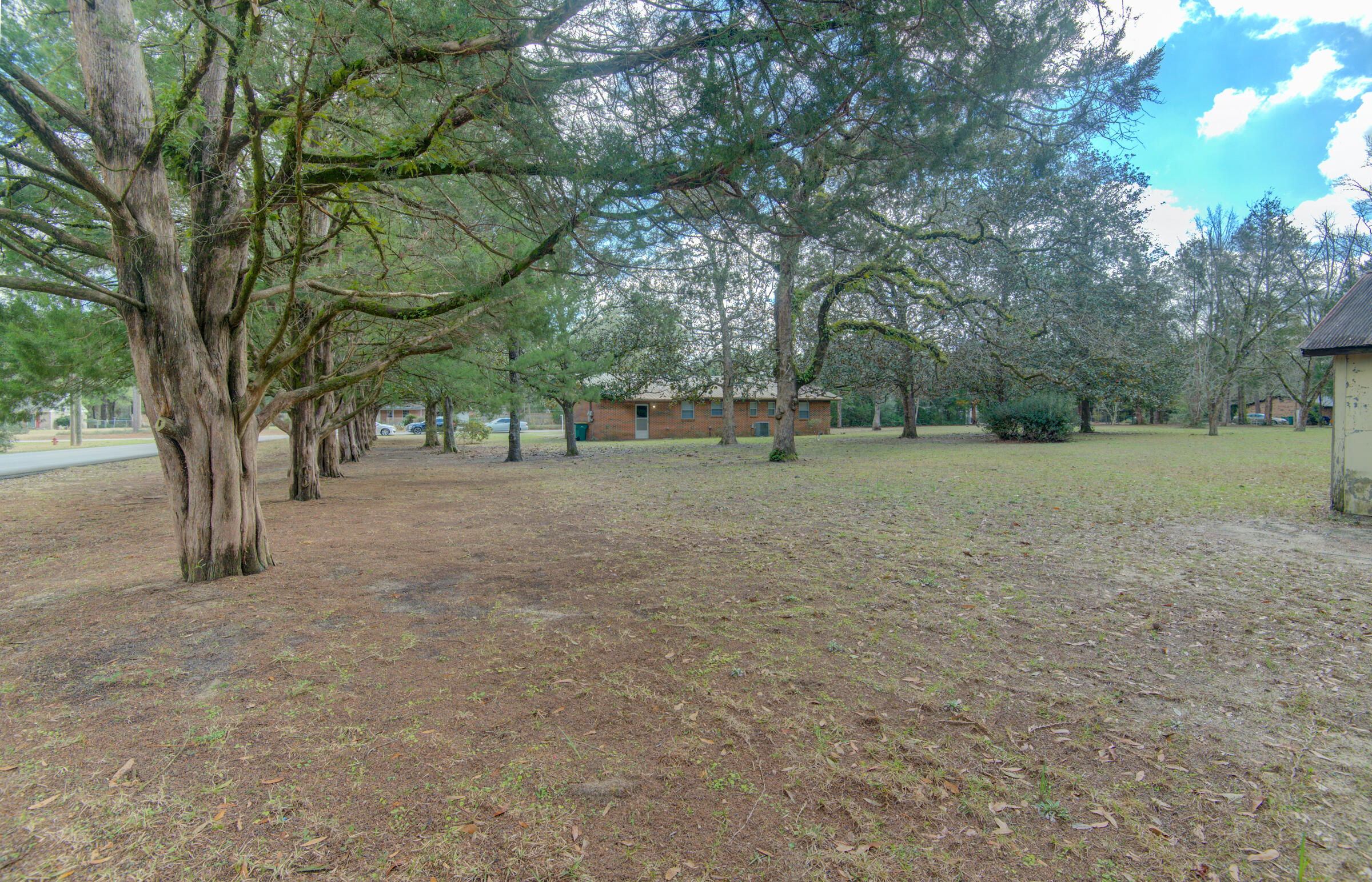 4826 Primrose Street Crestview, FL 32539 - Photo 3 of 25 a view of a field with trees in the background