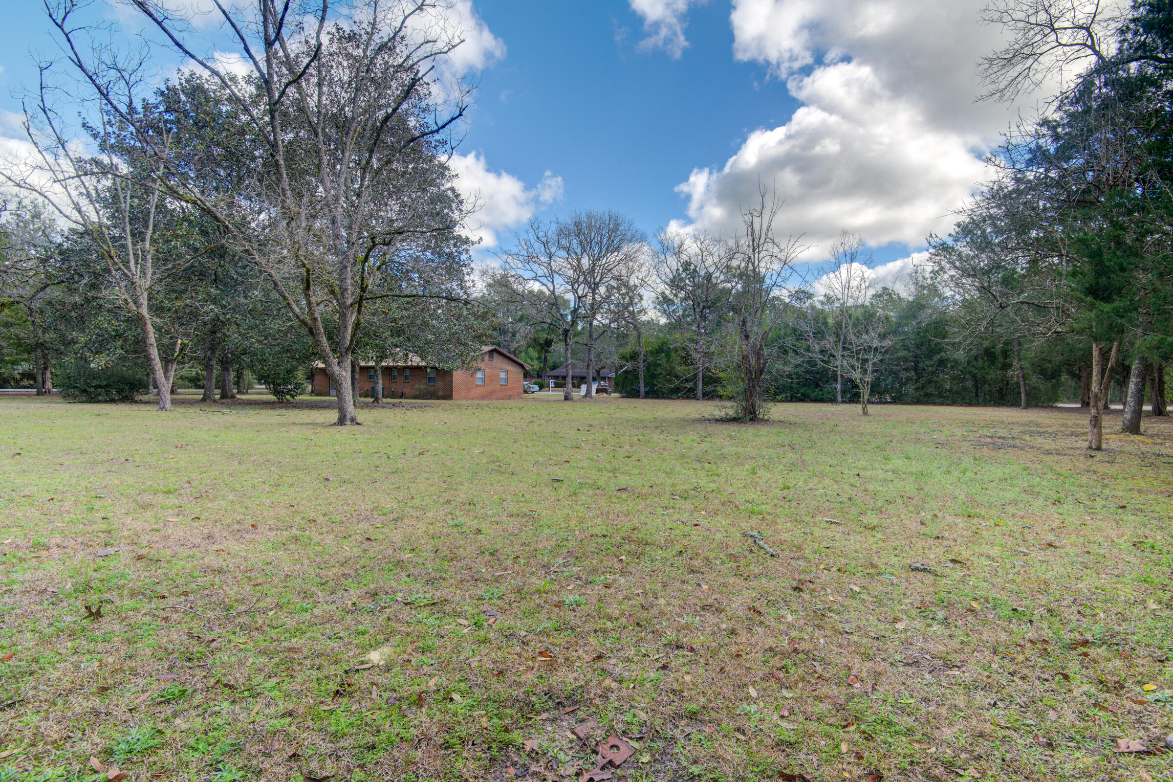4826 Primrose Street Crestview, FL 32539 - Photo 10 of 25 a view of a green field with trees in the background