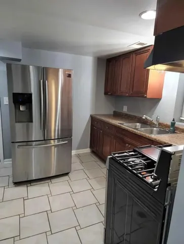 a kitchen with a stove a refrigerator and cabinets