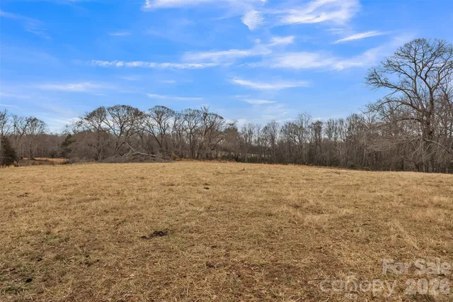 a view of a yard with wooden fence