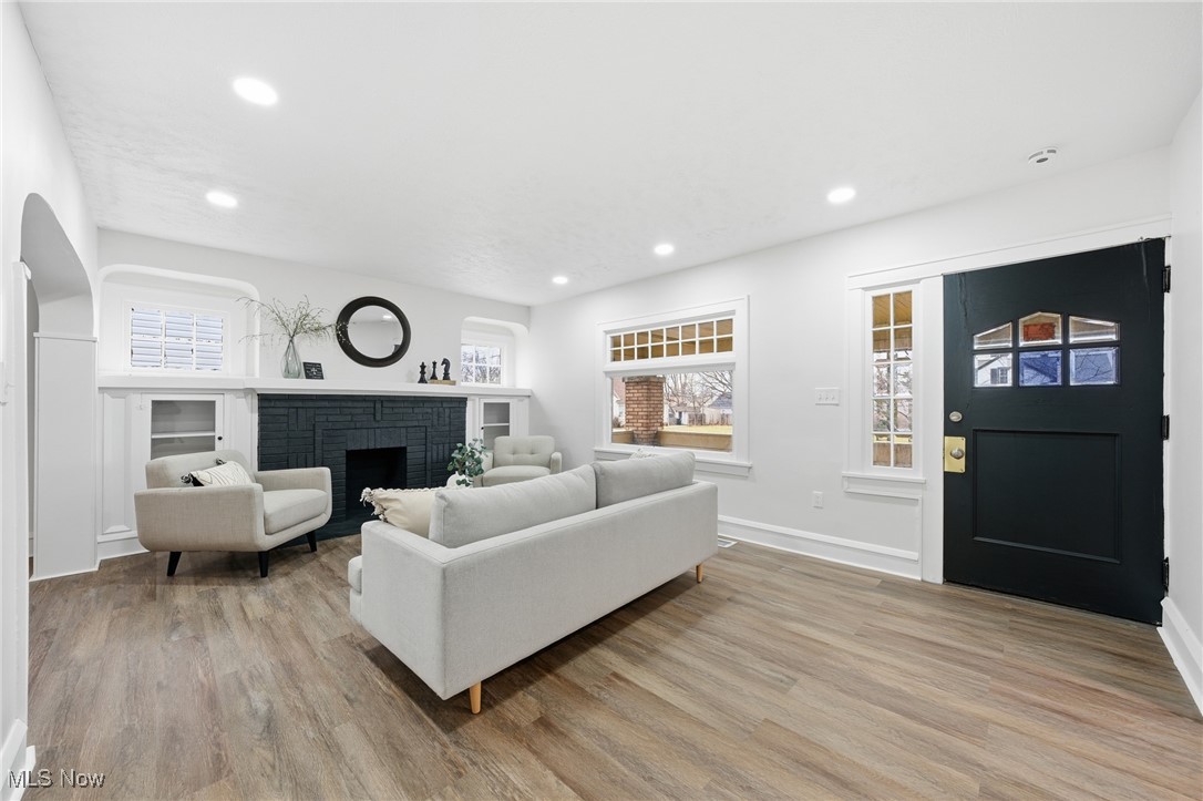 7911 Snow Road Parma, OH 44129 - Photo 2 of 44 Living room featuring a brick fireplace, recessed lighting, and light wood-style flooring