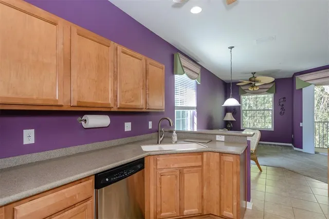 a kitchen with stainless steel appliances a sink cabinets and wooden floor