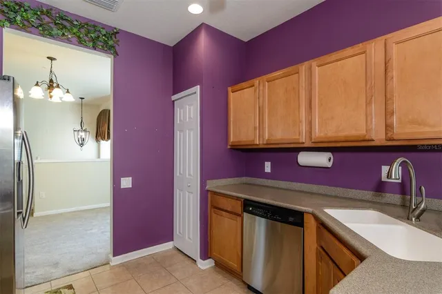 a living room with furniture a chandelier and a window