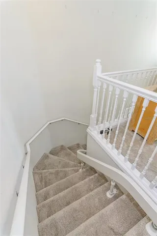 a view of a room with entryway chandelier fan and windows