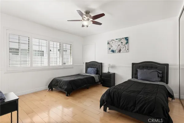 a bedroom with two beds and a window