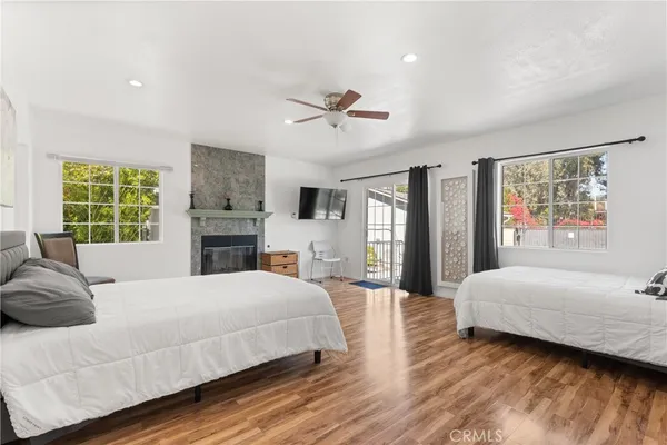 a bedroom with a large bed chandelier and a window