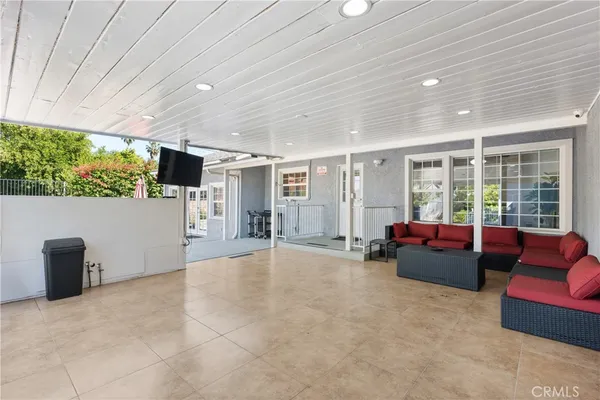a living room with furniture and large windows