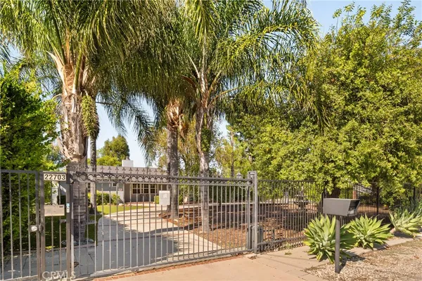 a view of a house with large trees