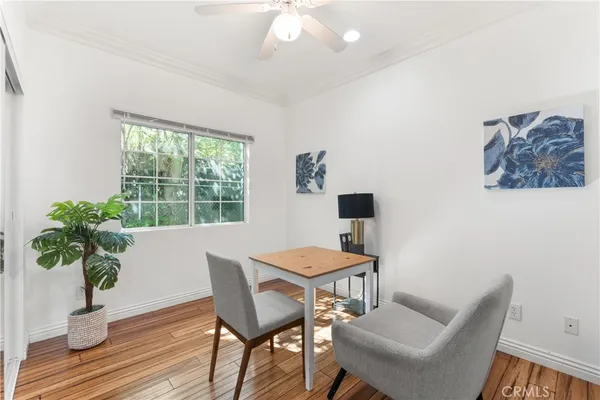 a view of a dining room with furniture window and wooden floor