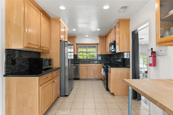 a kitchen with stainless steel appliances a refrigerator sink and cabinets