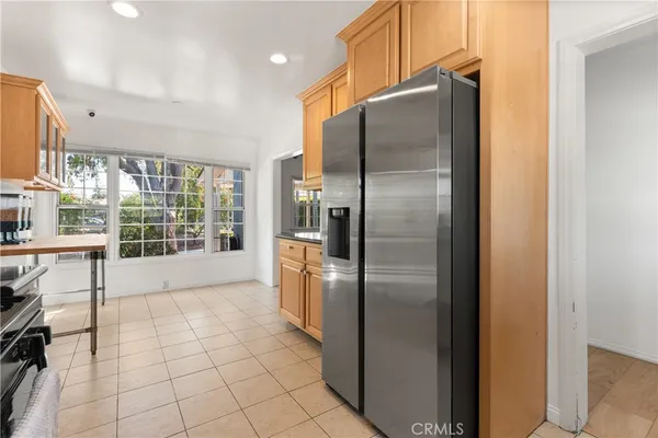 a kitchen with stainless steel appliances granite countertop a refrigerator and a sink